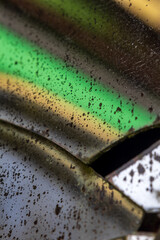 Aged mirror with cracks and degraded spots where the reflective backing is gone, distorting shapes...