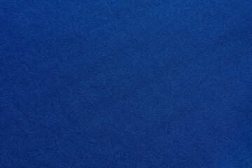 A close-up shot of smooth blue canvas fabric, perfect for use as a background or texture in design projects