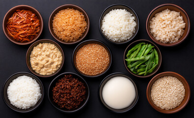 colorful asian food and dishes on a black background with empty space for