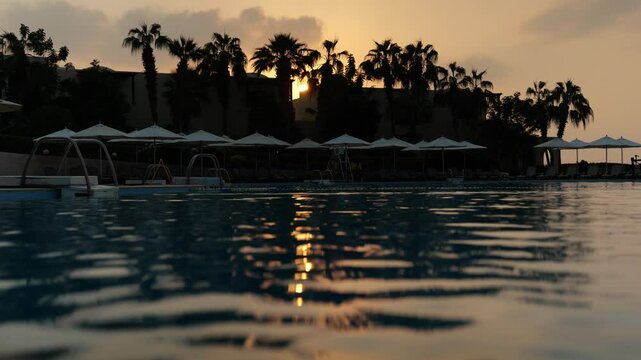 Experience the serene and picturesque Beauty of a Tranquil Sunset Reflection at a Poolside Oasis