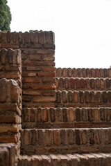 Close-up view of worn brick stairs leading upward, with the light sky visible in the background