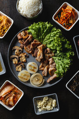 Delight in an array of expertly prepared dishes, featuring savory meats and fresh vegetables elegantly arranged on a rustic plate. Enjoy the inviting atmosphere and intriguing flavors