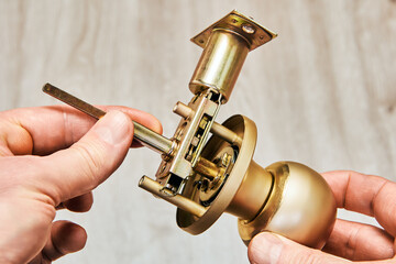 Brass doorknob reveals intricacy of its mechanical components and spindle mechanism.