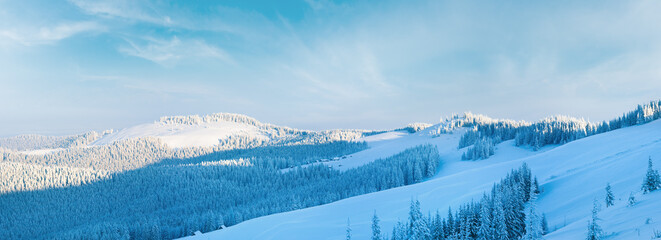 Morning winter calm mountain panorama with sheds group on slope (Carpathian Mountains, Ukraine). 