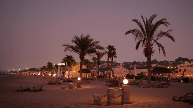 A beautiful, tranquil sunset beachside scene featuring palm trees, soft lights, and serenity