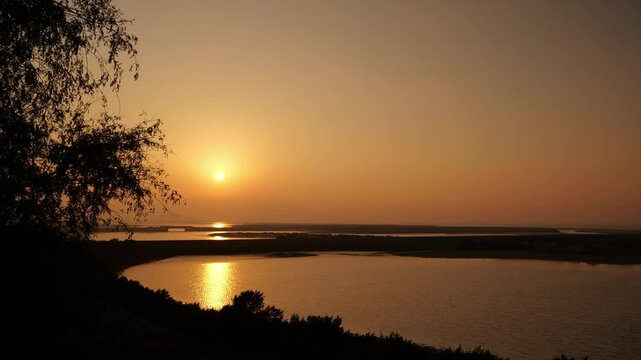 The Stunning Sunset Over a Beautifully Tranquil Water Landscape is Truly Breathtaking