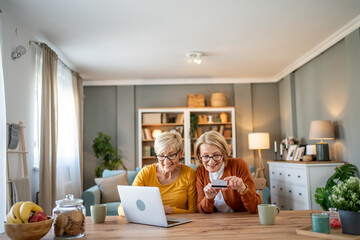 Senior women shopping online with credit card at home