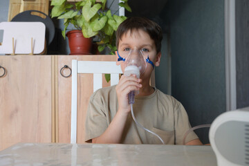 Child is inhaled with a masks nebulizer inhaler to treat a from coughing. Children's health, treatment, emergency care concept.