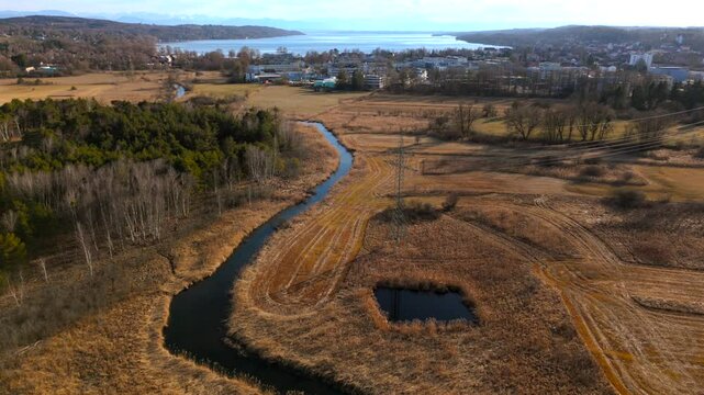 Aerial view of Upper Wurm River between Starnberg and Leutstetten, Bavaria. Clear water, wetlands, green meadows, and forests. Only outflow of Lake Starnberg, flowing through nature reserve in spring