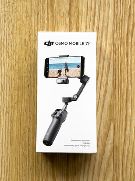 Dji osmo mobile 7p smartphone stabilizer packaging on wooden surface