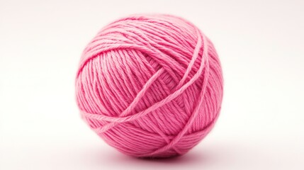 Pink ball of yarn on a white background. Suitable for crafts, knitting, crochet, or hobby-related themes