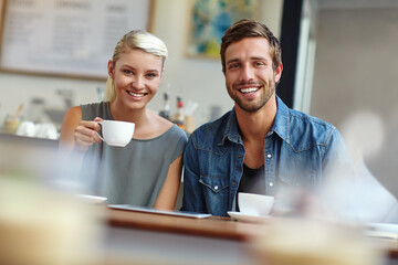 Cafe, couple and portrait with coffee for date, healthy relationship and bonding together with drink. Happy people, woman and man with connection for tea, cappuccino and love commitment in restaurant