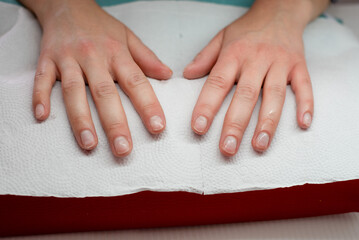 The master performs a manicure on the client