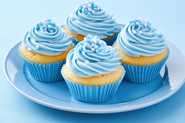 Deliciously decorated blue cupcakes with sugar crystals and frosting arranged on a soft blue plate for a dreamy dessert experience