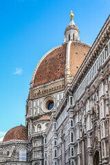 A large building of Florence Cathedral in Firenze Italy Toscana with a dome on top and a cross on top of it