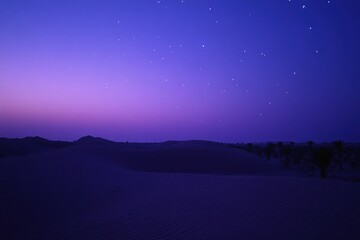 Naklejka premium Majestic desert dunes under a starry night sky, capturing the serene beauty of twilight—ideal for travel brochures, nature articles, or artistic backgrounds inspiring tranquility and wonder