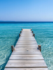 Obraz premium A rustic wooden dock leading to a secluded bay with stunning blue waters. Perfect for tropical escapes, travel photography, and nature-inspired designs