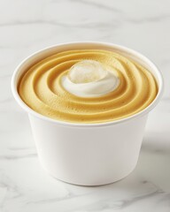 Delicious creamy dessert in a cup with a smooth golden swirl.