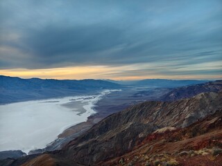 A panoramic overlook of Death Valley from Dante's View, capturing the dramatic play of light and shadow at sunset.