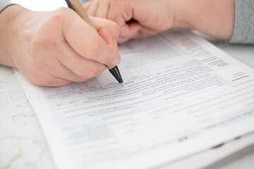 woman fills out a tax form at home.