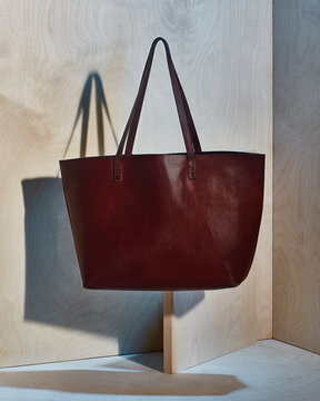 bag bag tote red maroon leather wood background