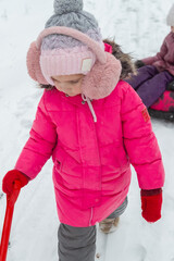 Father and daughters ride downhill on a Snow tubing in the park on the winter holidays