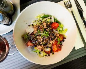 Spanish tuna salad with confit leek and modena served on a plate in a restaurant