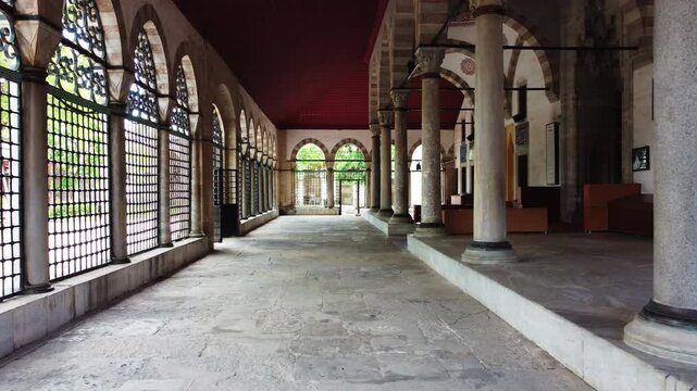 The porticos of the Atik Valide Mosque. They reveal the aesthetics of Ottoman architecture. The forward movement of the drone takes the viewer on a journey through the passage.