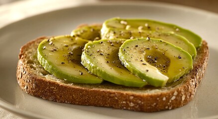 Sliced avocado with seasoning on a piece of toasted bread. A simple, healthy, and delicious meal.