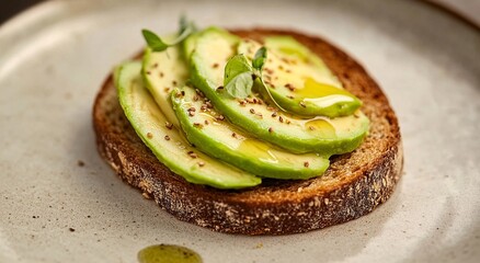 Delicious avocado toast with a drizzle of olive oil and herbs.  A simple yet elegant breakfast or brunch option.