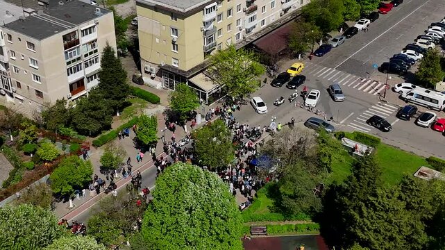 Aerial view of people gathering in front of Annunciation Church on a sunny day in Giurgiu, Romania