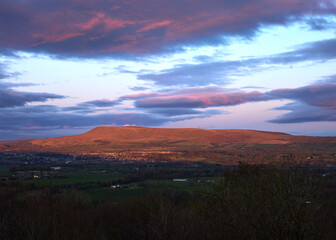 Last light hitting the hill and under side of the clouds, Pendle Hill from Longridge Fell, Clitheroe, Lancashire, UK