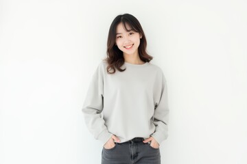 Obraz premium Half-Length (Waist-Up) portrait of young stylish smiling Japanese female model in casual wear isolated on pure white background looking at camera