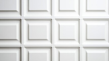 White coffered ceiling forming a geometric pattern with recessed panels and decorative elements, creating a sophisticated and elegant ambiance