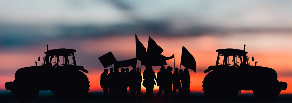 Silhouette of protesting farmers with tractors and agricultural equipment against the background of sunset. Farmers protesting against low prices for their products. Strike of agricultural workers.