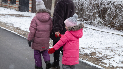 Family goes for a walk in winter in warm parks