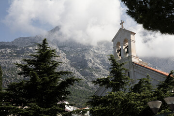 A picturesque view of the church in Baška Voda, Croatia, nestled against the backdrop of the...
