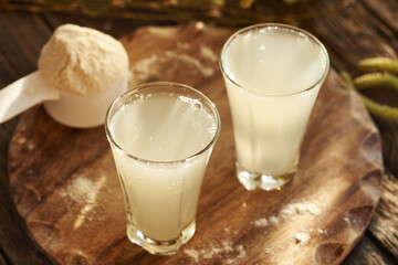 Two glasses of fresh natural whey with whey protein powder