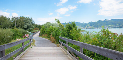 idyllic lakeside walkway Gwatt, with wooden bridges. landscape Thunersee Bernese Oberland