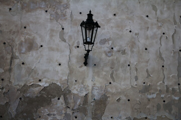 A charming close-up of a vintage lamp mounted on the wall of Višegrad, a historic site in Prague,...