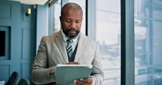 Tablet, research and mature businessman by window in office reading stock market development for investment. Digital technology, communication and financial manager with email for finance proposal.