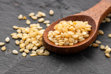 Raw organic sesame seeds in a spoon - Sesamum indicum