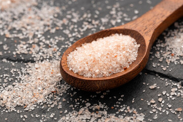 Pink Himalayan salt in spoon - Fine crystals sprinkled.