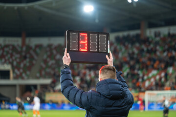 Technical referee shows 3 minutes added time during the football match.