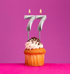 Birthday card on violet background - Candle number 77