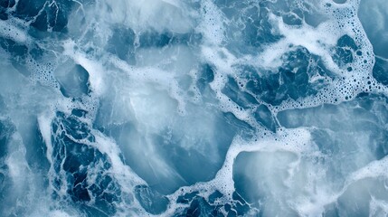 Fototapeta premium Close-up view of blue ocean water with foam and waves.