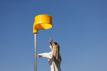 A Modern Artistic Encounter with an Eye-Catching Yellow Structure Against a Clear Blue Sky...