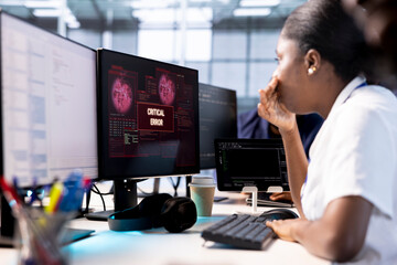 Anxious cybersecurity employee panicking while monitoring security incidents affecting server hub...