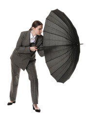 Young woman with black umbrella on white background