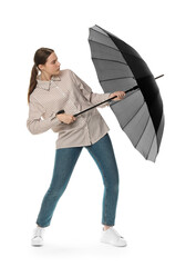 Young woman with black umbrella on white background